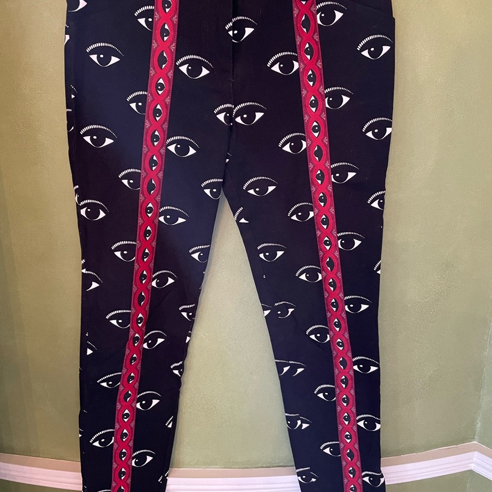 Kenzo black jeans with evil eye logo and trim.